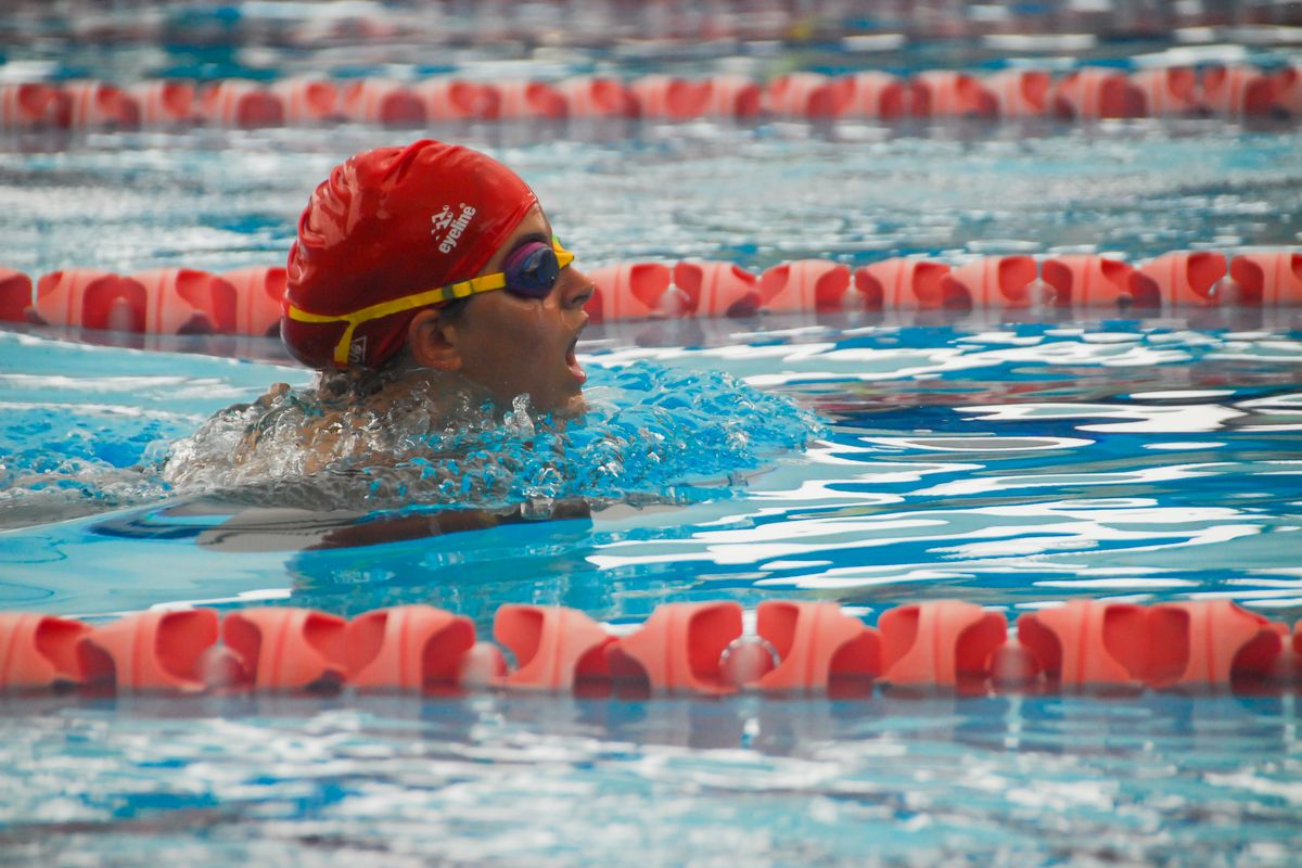 A swimmer in goggles and cap