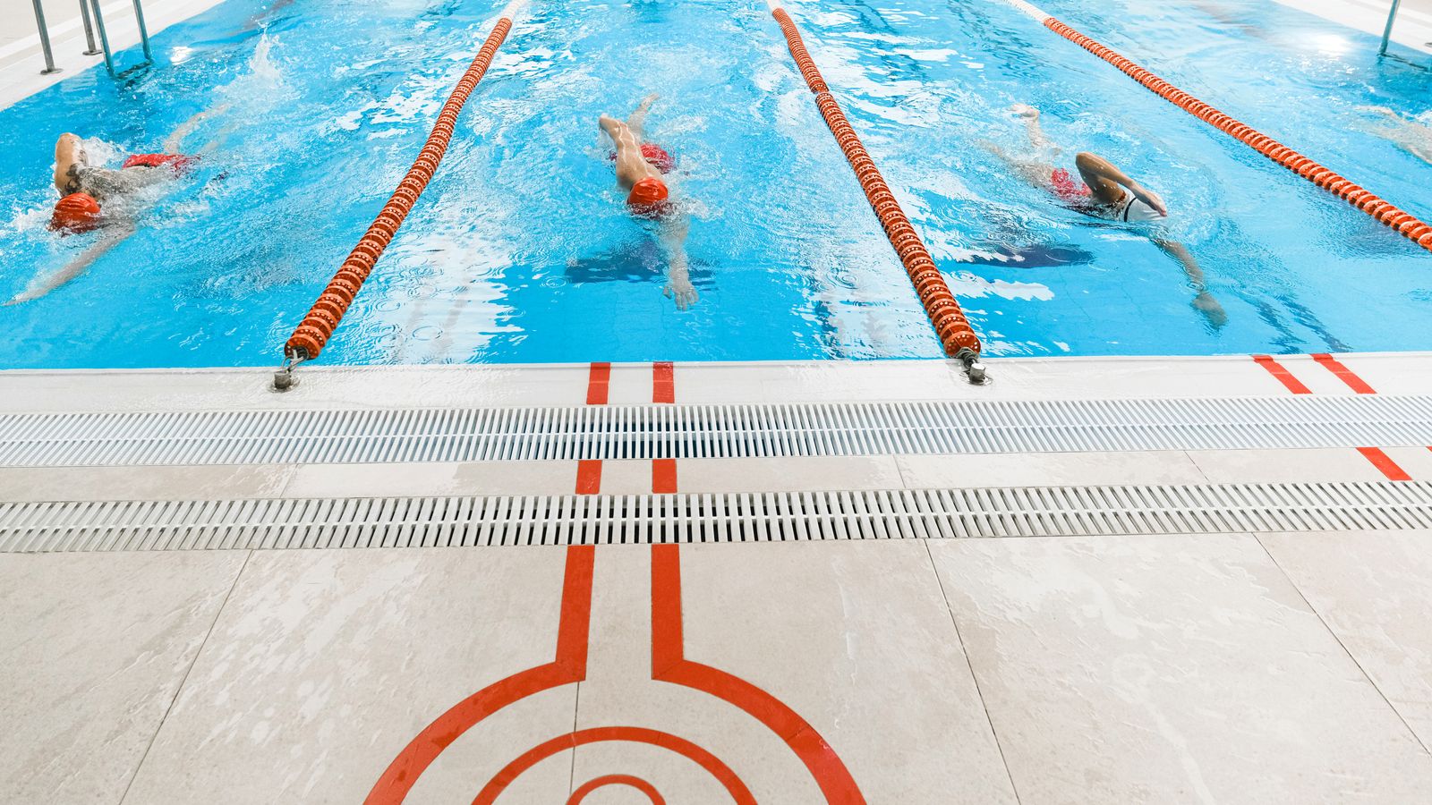 Swimmers in an indoor lane pool